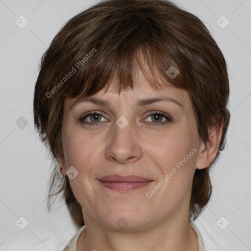 Joyful white adult female with medium  brown hair and grey eyes