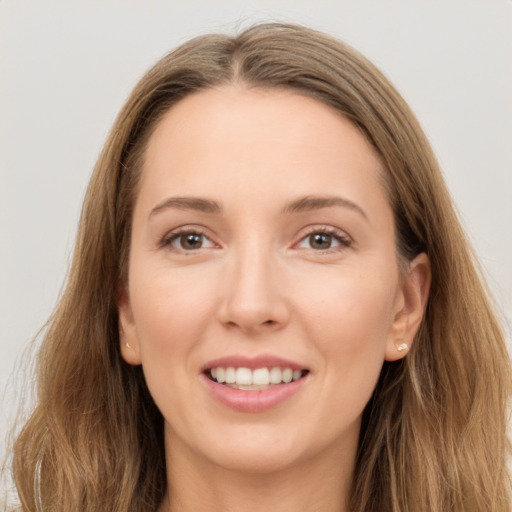 Joyful white young-adult female with long  brown hair and grey eyes