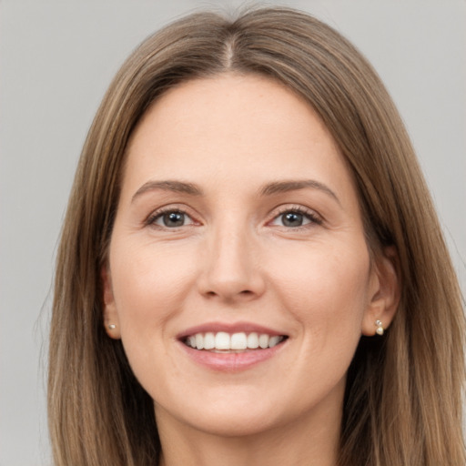 Joyful white young-adult female with long  brown hair and grey eyes