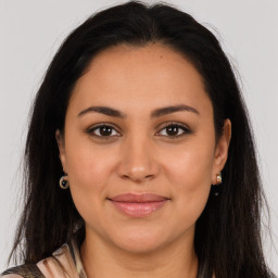 Joyful latino young-adult female with long  brown hair and brown eyes