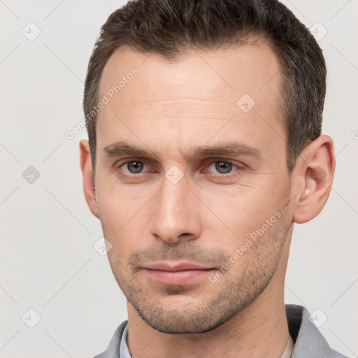 Neutral white young-adult male with short  brown hair and brown eyes