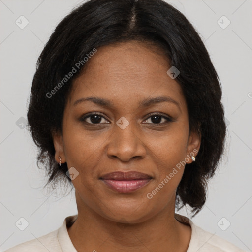 Joyful black adult female with medium  brown hair and brown eyes