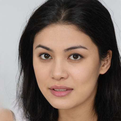 Joyful asian young-adult female with long  brown hair and brown eyes