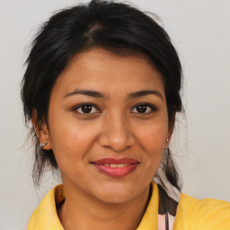 Joyful latino young-adult female with medium  brown hair and brown eyes