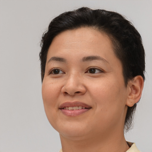 Joyful asian young-adult female with short  brown hair and brown eyes