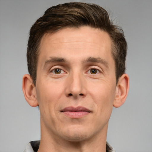 Joyful white adult male with short  brown hair and brown eyes
