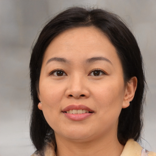 Joyful asian young-adult female with medium  brown hair and brown eyes