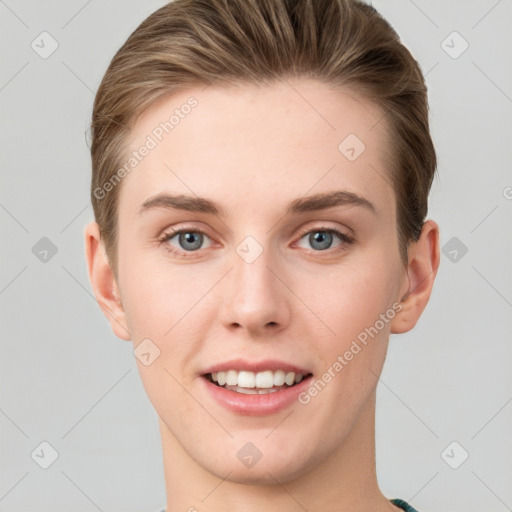 Joyful white young-adult female with short  brown hair and grey eyes