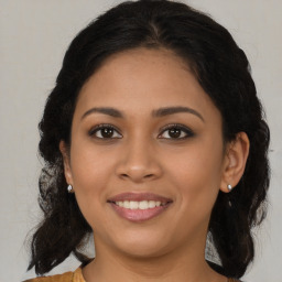 Joyful latino young-adult female with medium  brown hair and brown eyes