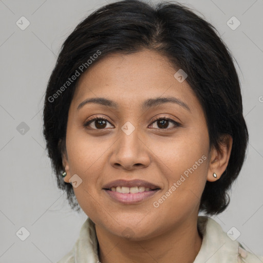 Joyful latino young-adult female with medium  brown hair and brown eyes