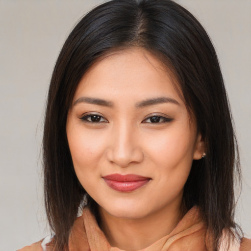 Joyful asian young-adult female with medium  brown hair and brown eyes
