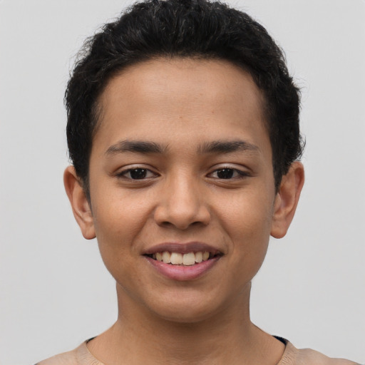 Joyful latino young-adult male with short  brown hair and brown eyes