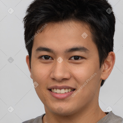 Joyful asian young-adult male with short  brown hair and brown eyes