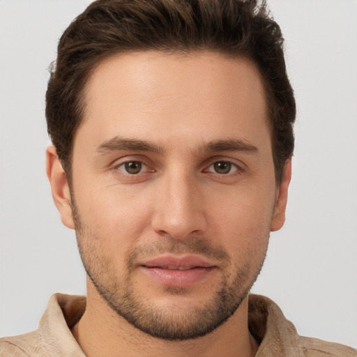 Joyful white young-adult male with short  brown hair and brown eyes