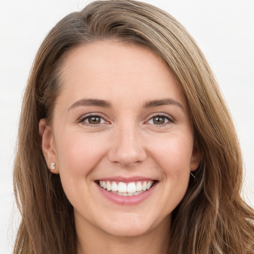 Joyful white young-adult female with long  brown hair and grey eyes