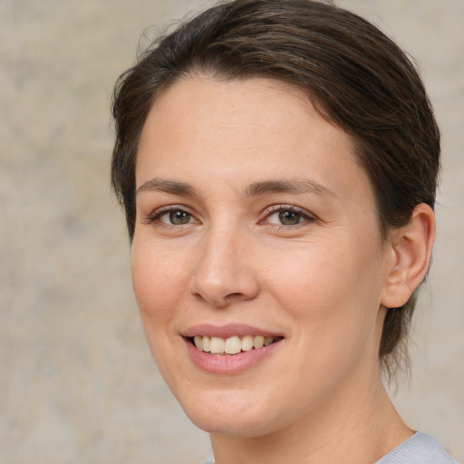 Joyful white young-adult female with medium  brown hair and brown eyes