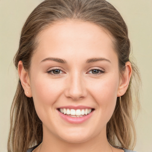 Joyful white young-adult female with long  brown hair and grey eyes