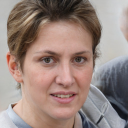 Joyful white adult female with medium  brown hair and brown eyes