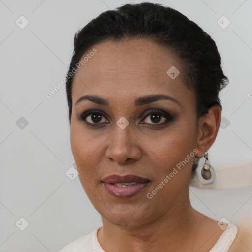 Joyful black young-adult female with short  black hair and brown eyes