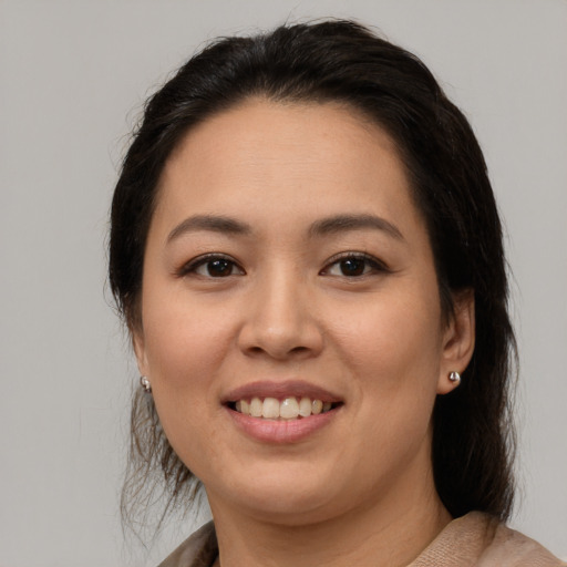 Joyful latino young-adult female with medium  brown hair and brown eyes