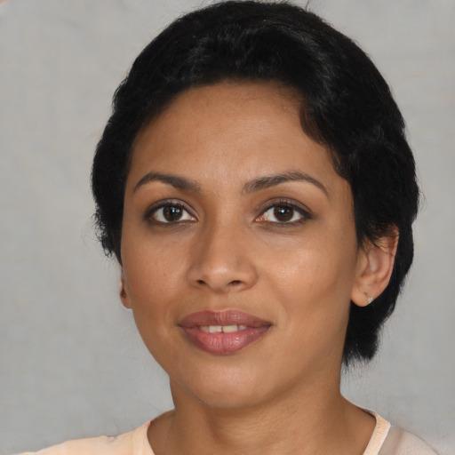 Joyful latino young-adult female with short  black hair and brown eyes