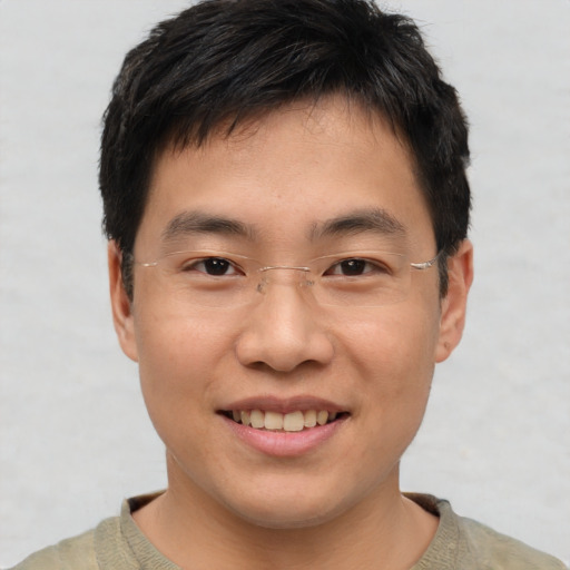 Joyful asian young-adult male with short  brown hair and brown eyes