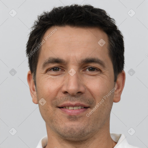 Joyful white adult male with short  brown hair and brown eyes