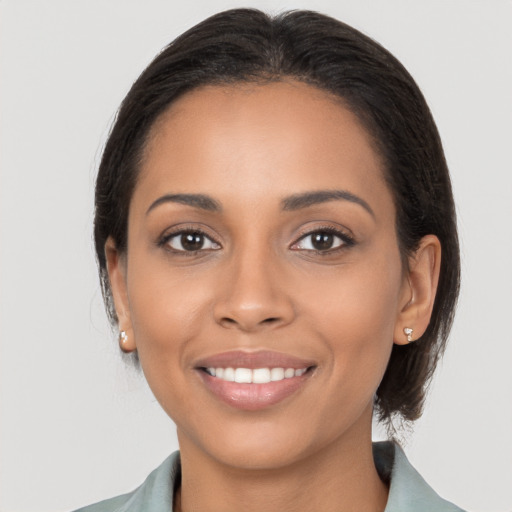 Joyful latino young-adult female with medium  brown hair and brown eyes