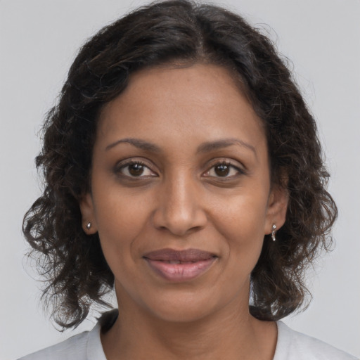 Joyful black young-adult female with medium  brown hair and brown eyes