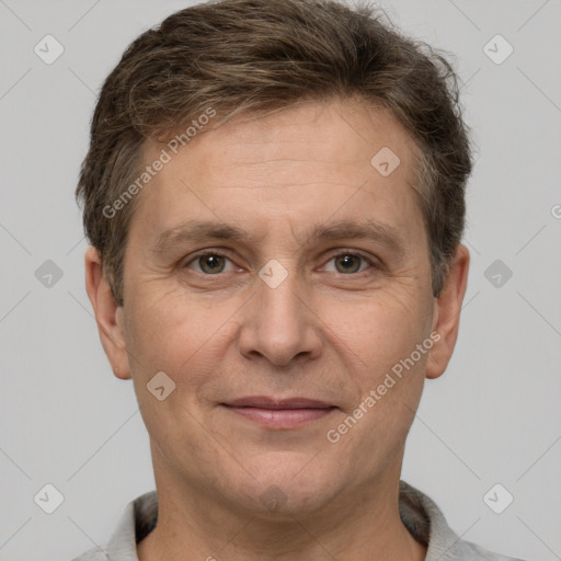 Joyful white adult male with short  brown hair and grey eyes