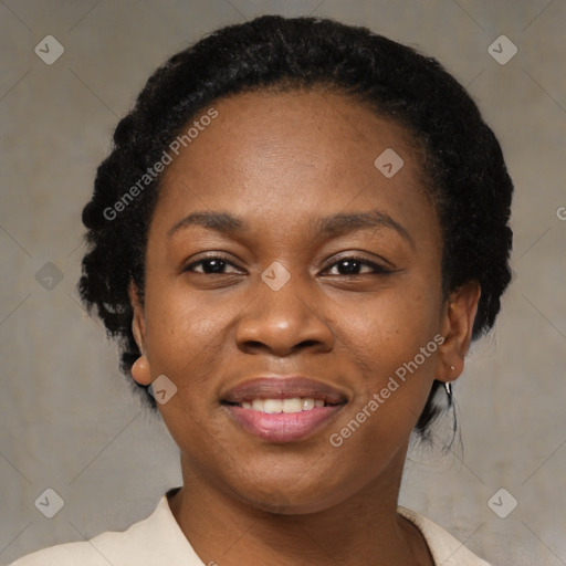 Joyful black young-adult female with short  black hair and brown eyes