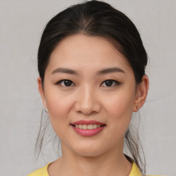 Joyful asian young-adult female with medium  brown hair and brown eyes