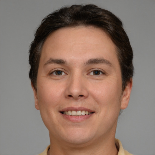 Joyful white young-adult male with short  brown hair and brown eyes