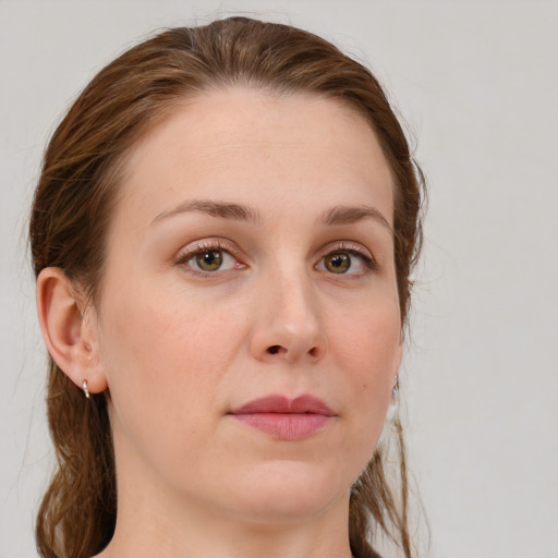 Joyful white young-adult female with medium  brown hair and blue eyes