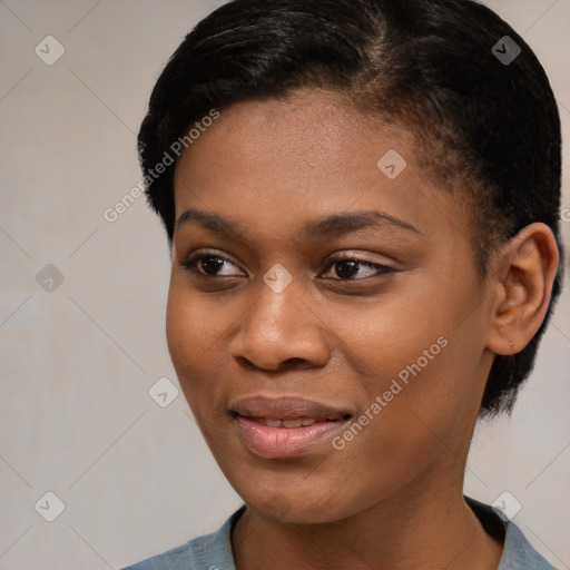 Joyful black young-adult female with short  brown hair and brown eyes