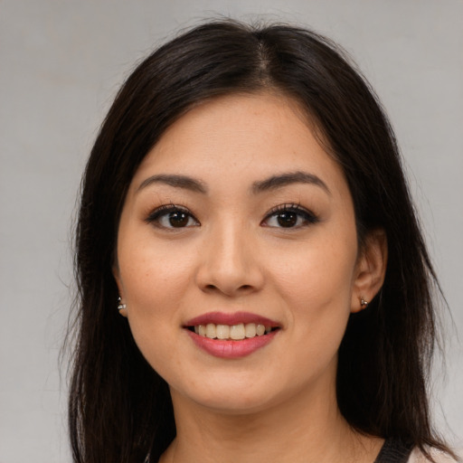 Joyful latino young-adult female with medium  brown hair and brown eyes