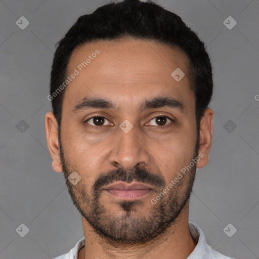 Joyful latino young-adult male with short  black hair and brown eyes