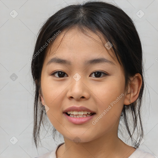 Joyful asian child female with medium  brown hair and brown eyes