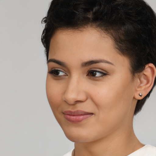 Joyful latino young-adult female with short  brown hair and brown eyes
