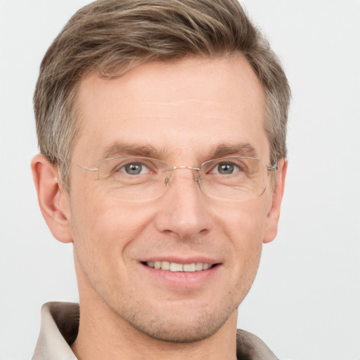 Joyful white adult male with short  brown hair and grey eyes