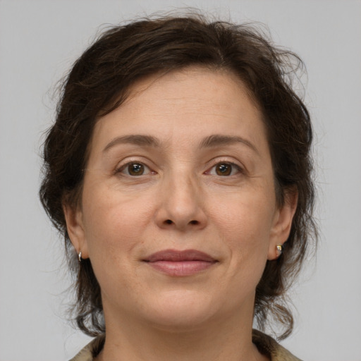 Joyful white adult female with medium  brown hair and grey eyes