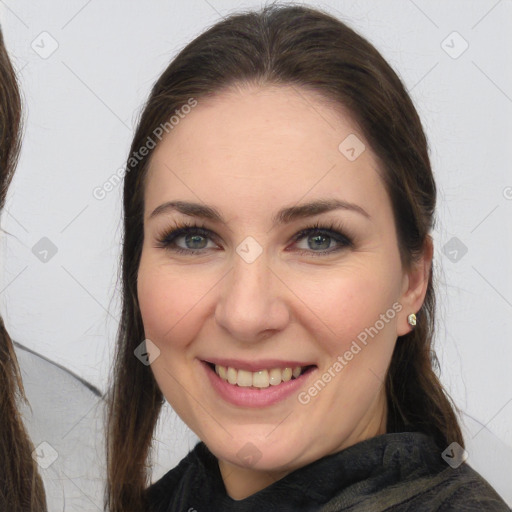 Joyful white young-adult female with long  brown hair and grey eyes