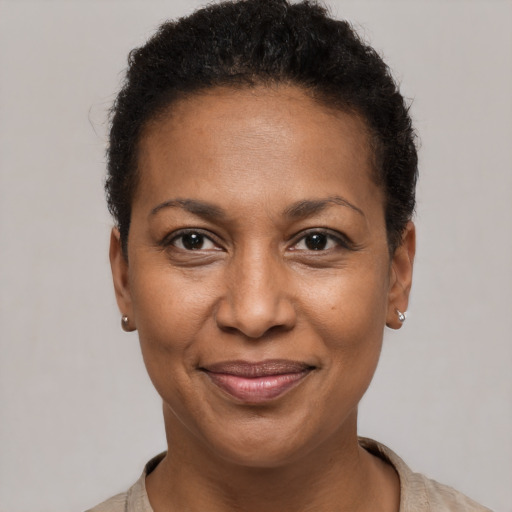 Joyful black adult female with short  brown hair and brown eyes