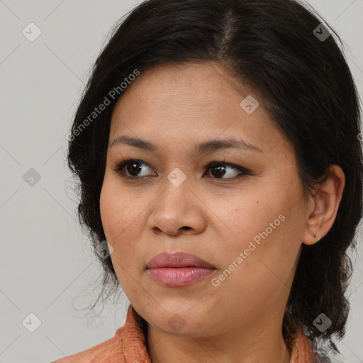 Joyful latino young-adult female with medium  brown hair and brown eyes