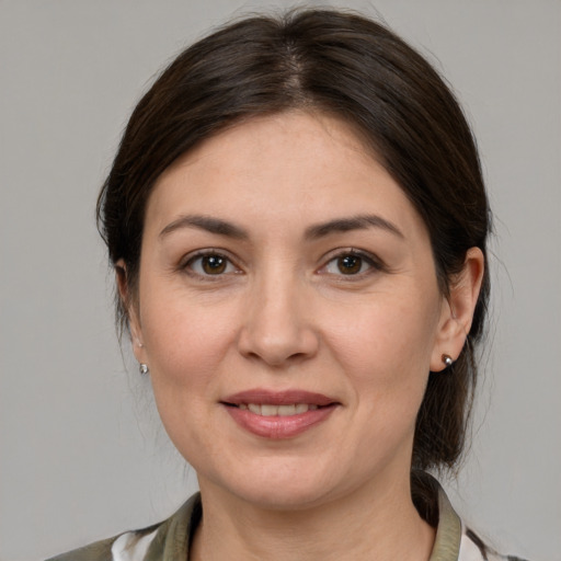 Joyful white adult female with medium  brown hair and grey eyes