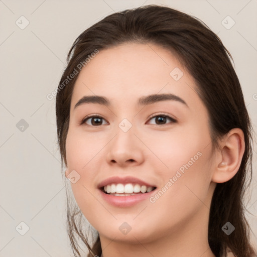 Joyful white young-adult female with long  brown hair and brown eyes