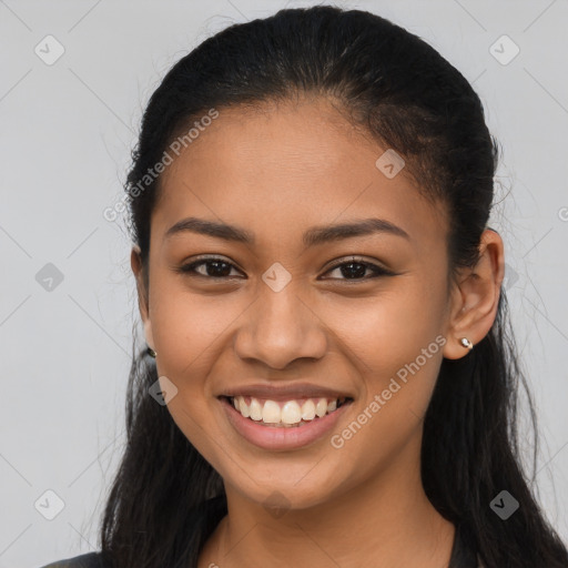 Joyful latino young-adult female with long  brown hair and brown eyes