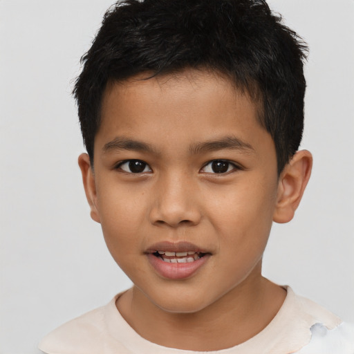 Joyful latino child male with short  brown hair and brown eyes