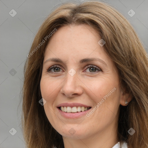 Joyful white adult female with long  brown hair and brown eyes