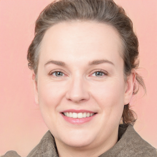 Joyful white adult female with medium  brown hair and blue eyes